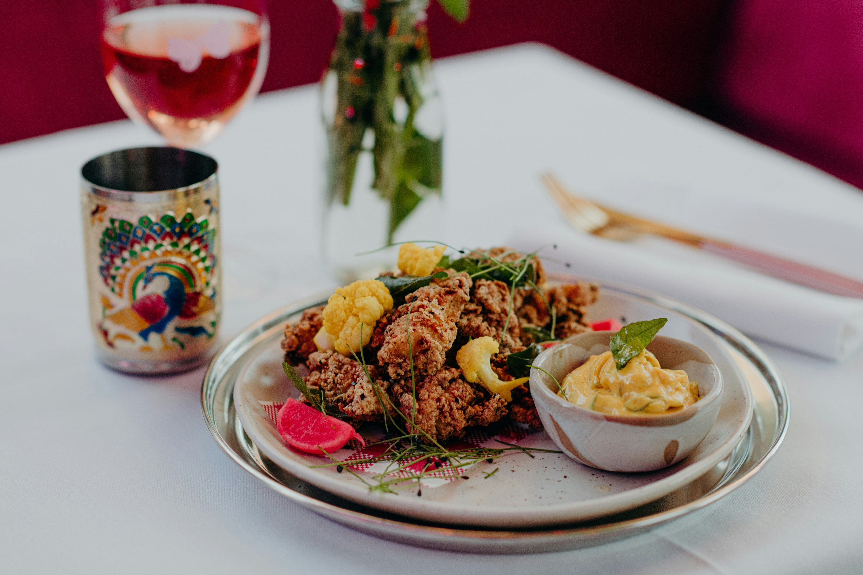 a plate of food and an ornate glass